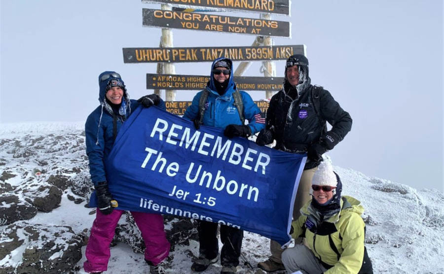 Bishop Coffey, Dr. Pat Castle, Bernadette Costello, and Dolores Meehan with LIFE Runners' “REMEMBER The Unborn” message atop Mt. Kilimanjaro (19,341 ft.) 