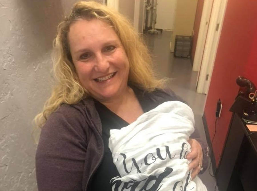 OB-GYN Poppy Daniels holding a baby born after she treated the child's mother with the Abortion Pill Reversal protocol