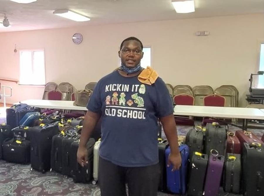 Pastor Sean Burch with suitcases he's collected for Suitcases With Hope