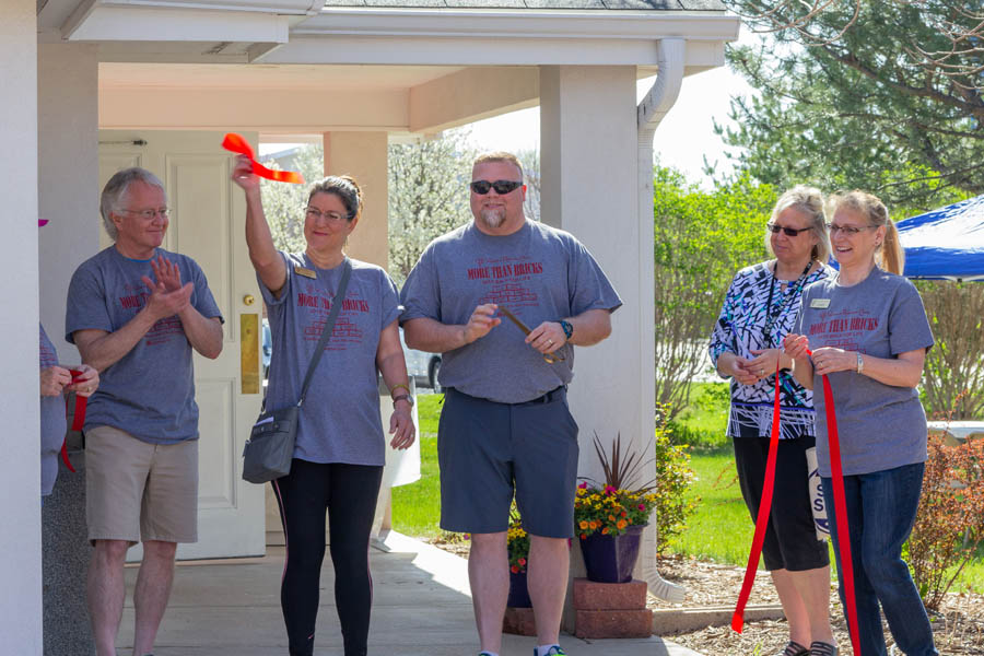 Members of the Chamber of Commerce conducted the ribbon-cutting, opening Women's Resource Center's new location this May.