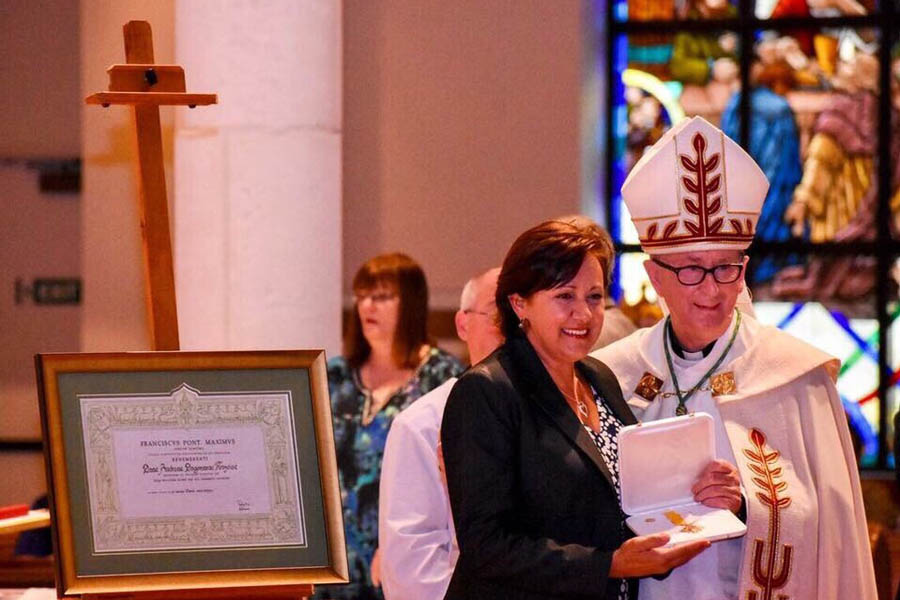 Andrea Krazeise, executive director of The Pregnancy Center of Sanford & Oviedo, accepts a medal and a document signed and sealed by Pope Francis.