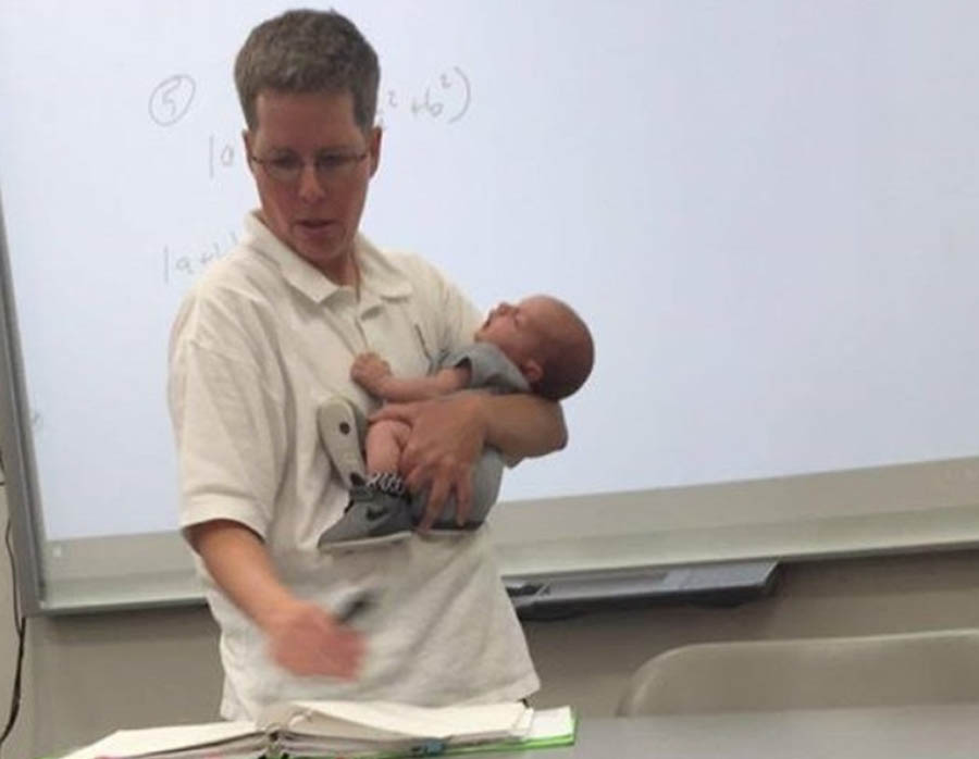 Professor Josie Ryan holds Sarah Thompson’s son Isaiah while teaching Thompson's math class at Lander University