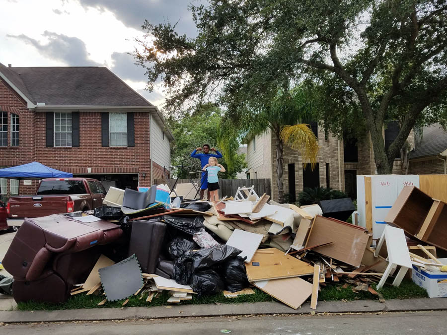 Debbie Simmons' oldest grandchild and youngest child atop the rubble of the Simmons' home following Hurricane Harvey.