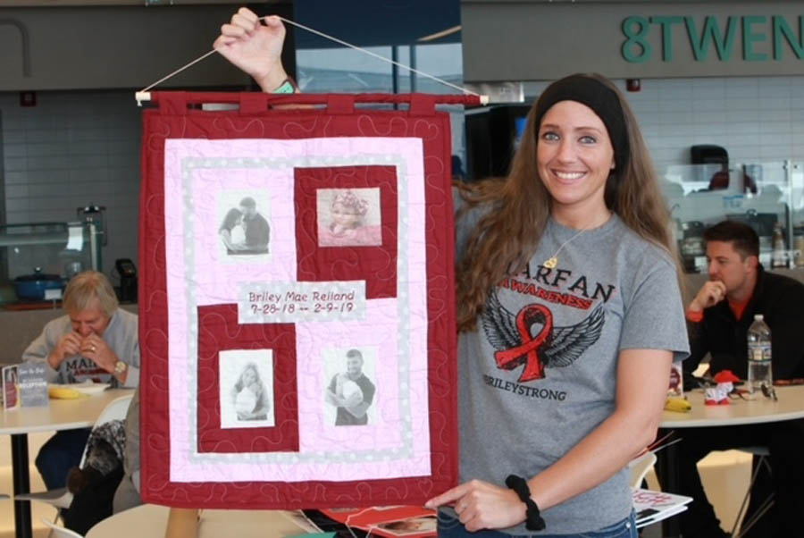 Benita Gallagher with images of her daughter Briley and their family at a Marfan syndrome awareness walk in March 2019