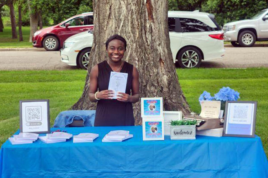 16-year-old Chloe Naslund with her book "Adoptive Love" at the North Dakota State Capital book festival June 21, 2023