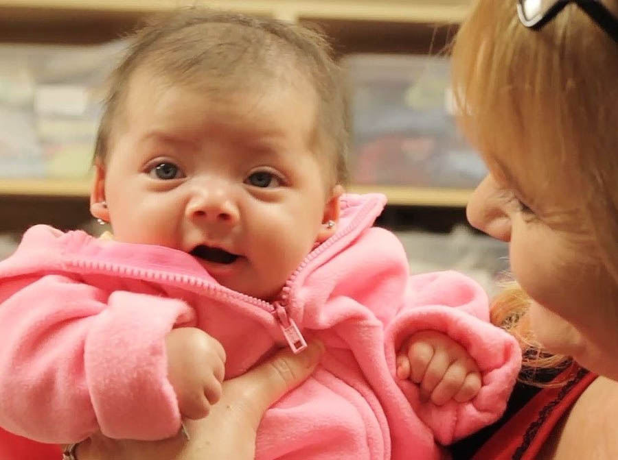 Cindy Young RN, nurse manager at CPC Women's Health Rescource's Napoleon and Wauseon centers, holding a client's daughter.