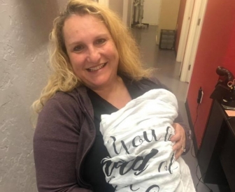 Dr. Poppy Daniels holds a baby saved through Abortion Pill Reversal