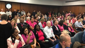 Hundreds of pro-lifers don pink at April 10 city council meeting to support Women&#039;s Care Center.