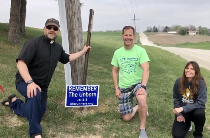 Fr. Michael Voithofer at the Ablaze House of Prayer, along with Pat Castle, and Bernadette Costello and the Life Runners &quot;REMEMBER The Unborn sign&quot; that helped baby Waylon&#039;s mother choose life